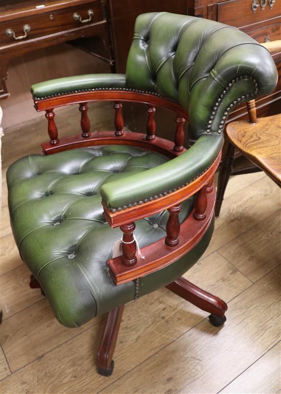 A green leather button back captains chair